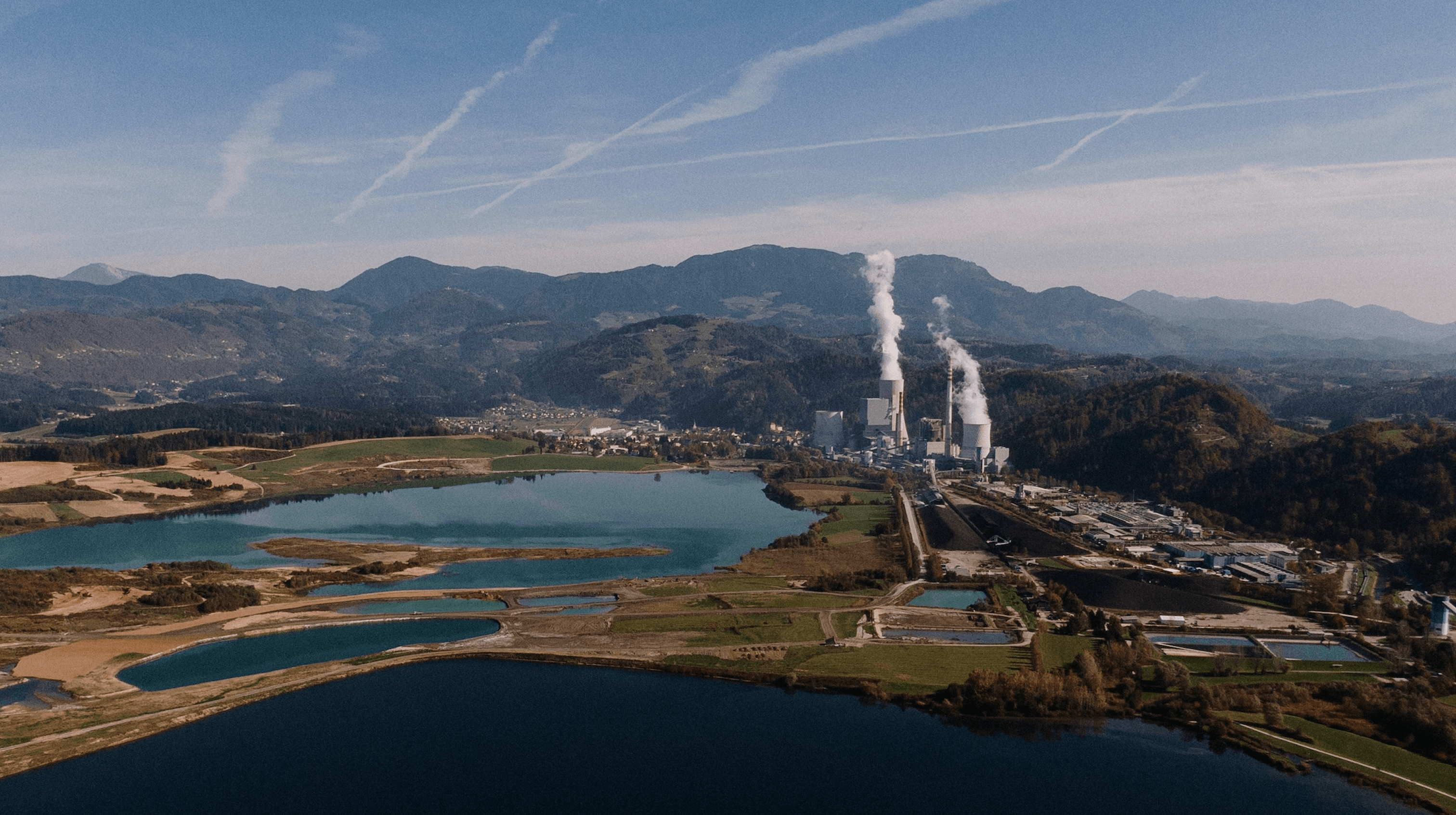 aerial-shot-landscape-surrounded-by-mountains-lakes-with-industrial-disaster